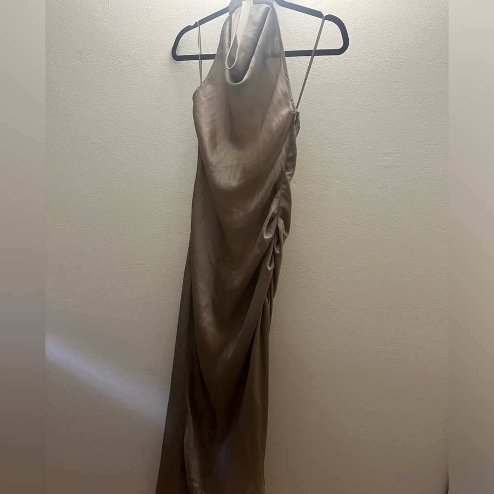 This silk dress has never been worn. It’s a size medium.